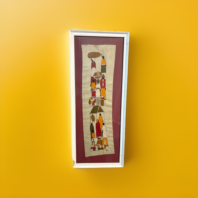 This is a framed batik art panel depicting an African market scene. gallery