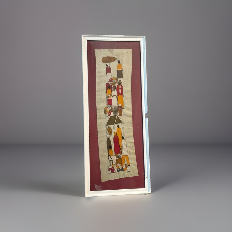 This is a framed batik art panel depicting an African market scene.