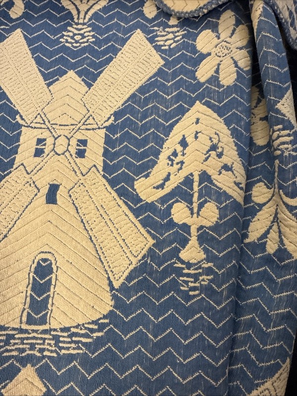 Hand-sewn blue and white textile with windmill and folk art motifs. gallery