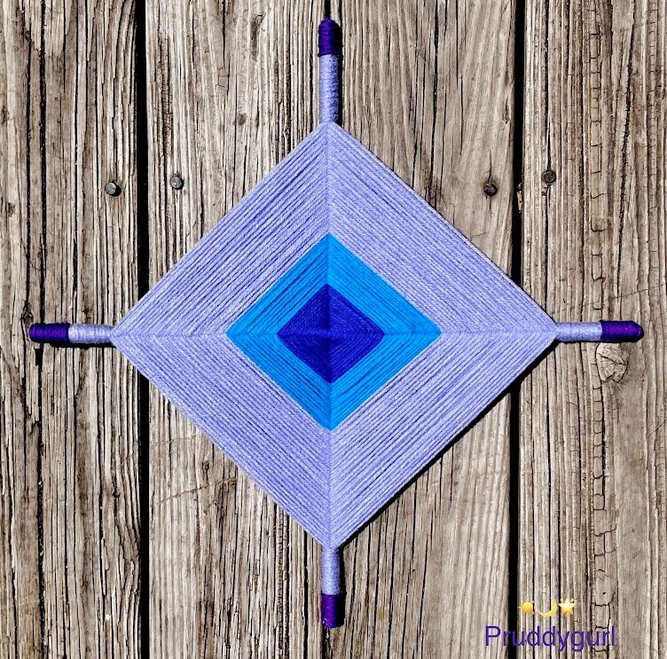 Ojo de Dios/God’s Eye 18″ violet/blues/aqua-acyrlic yarn
